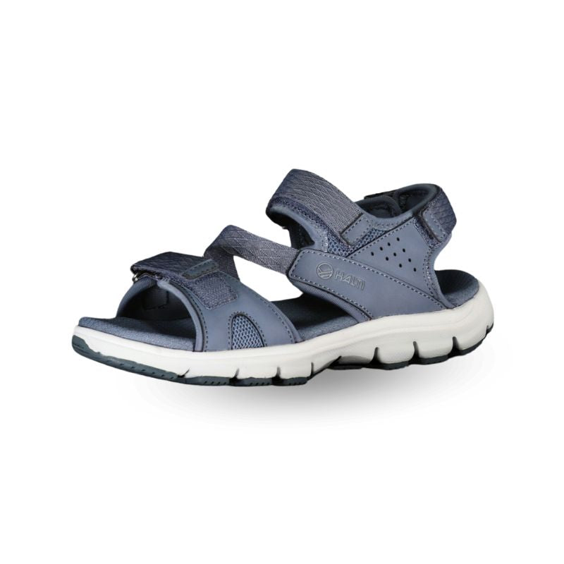 Die Halti Resa Damen Sandale, blau und grau mit Klettverschluss und weißer Polstersohle, abgebildet auf weißem Hintergrund.