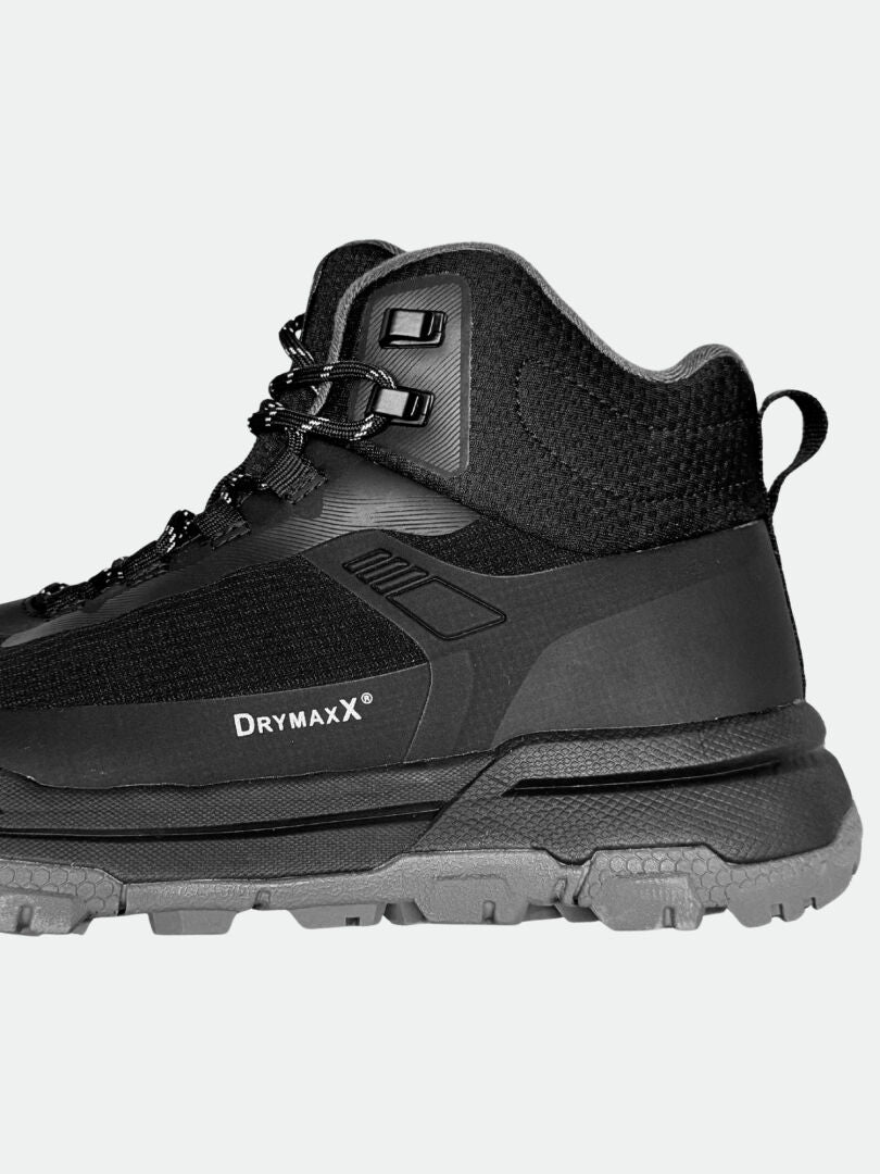 Der Halti Fara 3 DX Mid Damen Outdoor Schuh, schwarz/grau mit DRYMAXX, Nähten und robuster Sohle, von der Seite gezeigt.