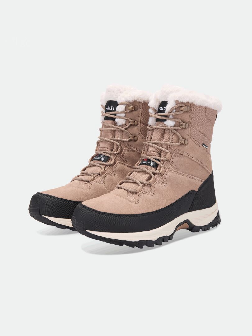 Halti Tornio 2 DX Winterschuhe: beige Schnürstiefel mit weißem Kunstfellbesatz, schwarzen Schlammschutzkanten und Thinsulate-Isolierung.