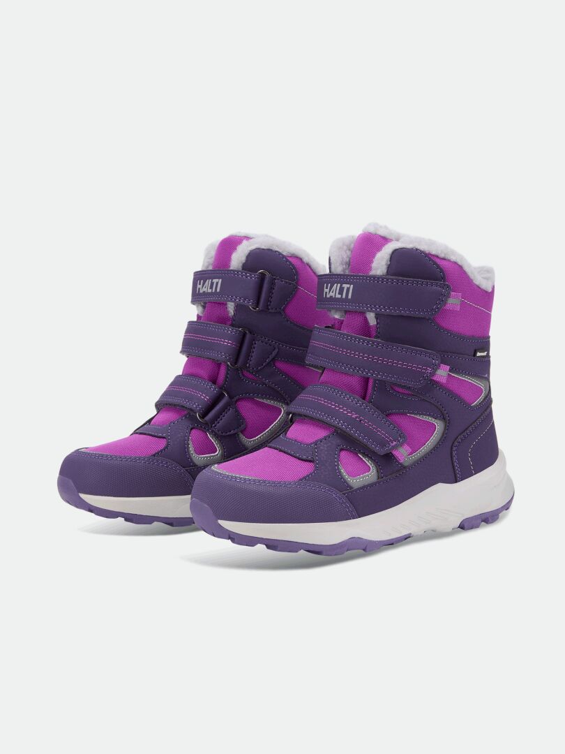 Halti Reiss 3 DX Winterschuhe für Kinder in Lila/Rosa mit Klettverschluss, weißen Sohlen und reflektierenden Details.
