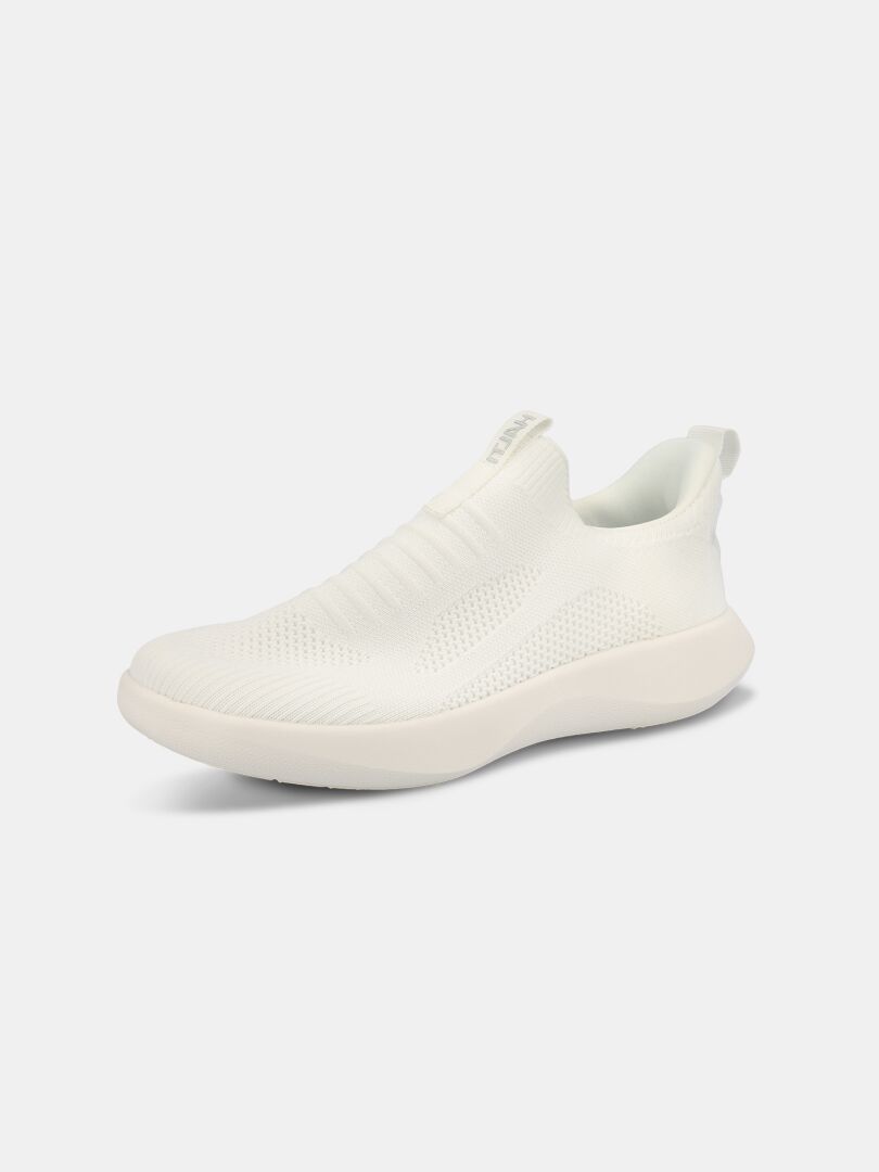 Der Halti Snabb 2 StepIn Sneaker Damen ist ein weißer Slipper mit gestricktem Obermaterial, dicker Gummisohle und StepIN-Fersen-Design.