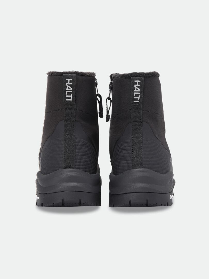 Rückansicht von zwei schwarzen Halti Kajuk Mid DX IC Winterschuhen mit seitlichen Reißverschlüssen, pelzgefütterten Kragen und Michelin Ice Grip-Sohlen.