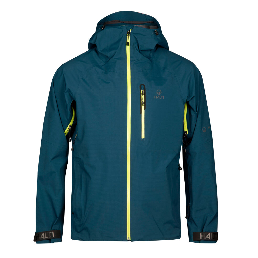 Die Halti Alpine 3L DX Skijacke Unisex ist eine blaue, wasserdichte Kapuzenjacke mit gelben Reißverschlüssen, ideal für das Skifahren im Backcountry.