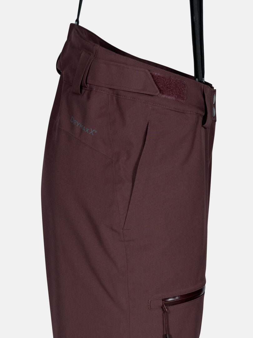 Seitenansicht der Halti Carvey II DX Skihose Damen in kastanienbraun mit Tasche, Gürtelschlaufen, Reißverschluss und DrymaxX-Logo am Bund.