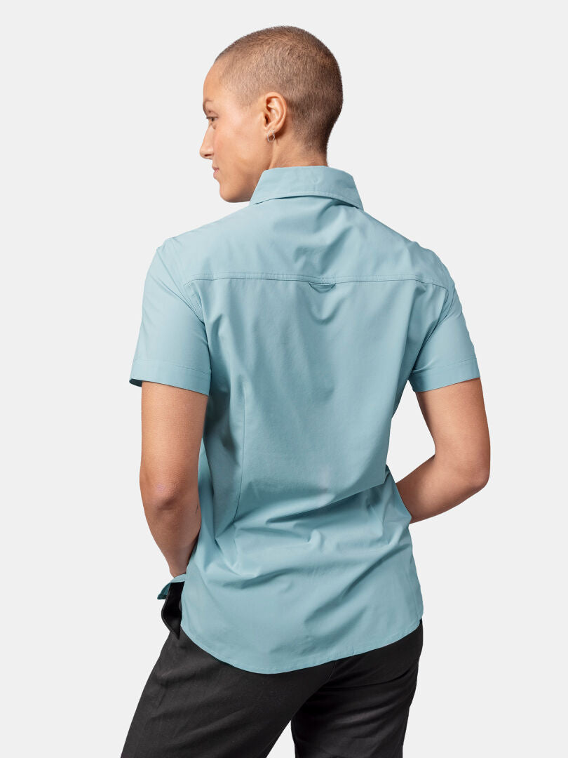 Person mit kurzen Haaren, von hinten gezeigt, trägt das Halti Samoy Funktionshemd Damen und eine dunkle Hose.