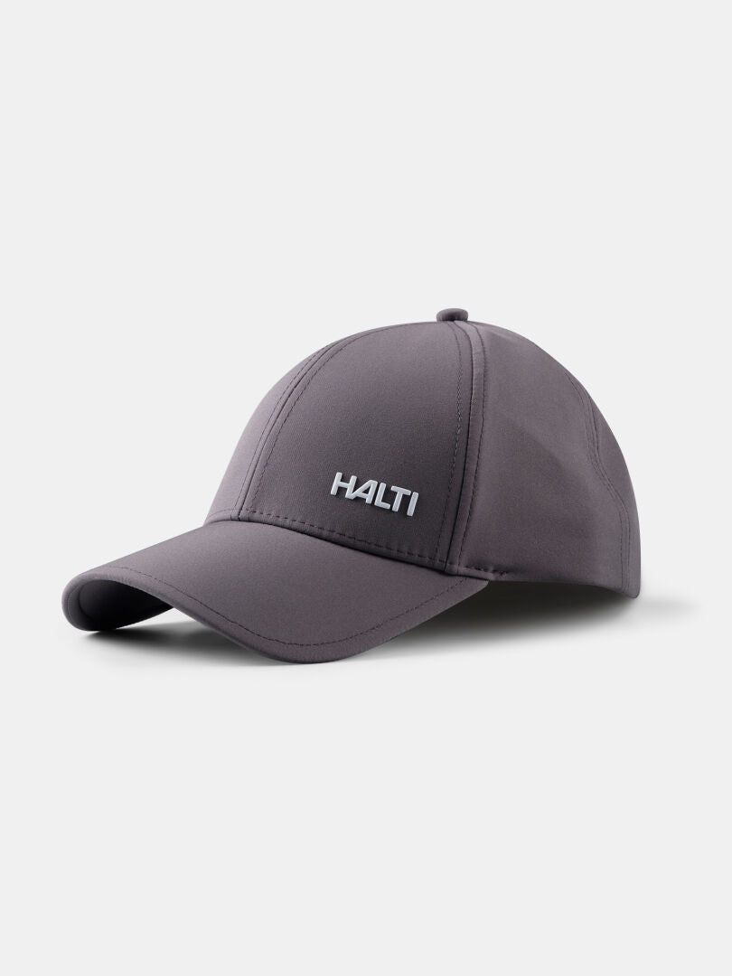 Graue Mattas Baseballkappe von Halti mit Quick Dry Stretch, HALTI-Logo auf der Vorderseite, auf weißem Hintergrund.