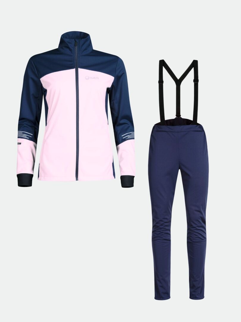 Das Halti Siide Langlaufanzug Set ist ein 2-teiliges Softshell mit einer rosa/navy Jacke und einer navy Hose mit schwarzen Hosenträgern.