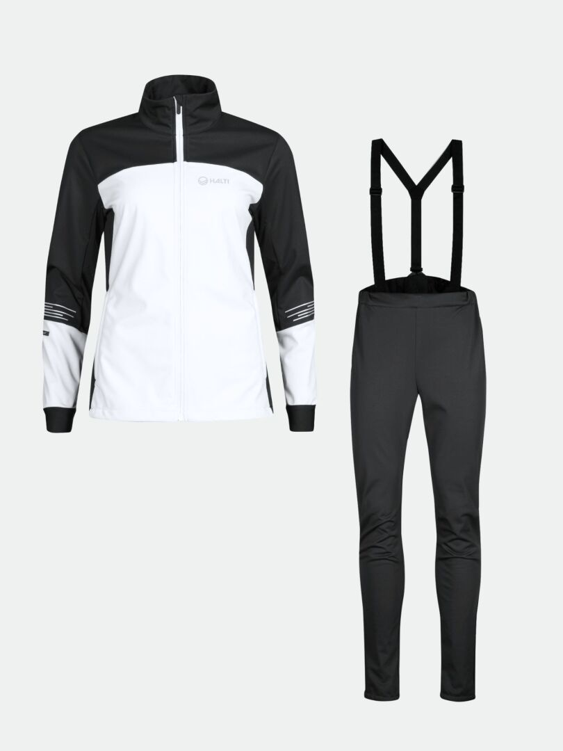 Halti Siide Langlaufanzug Set: schwarze Stormwall-Stretch-Reißverschlussjacke und Hose mit Hosenträgern auf einfarbigem Hintergrund.