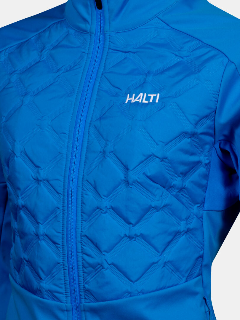 Nahaufnahme der Halti Framover Hybrid Langlaufjacke Damen in blau mit geometrischer Steppung und Frontreißverschluss.