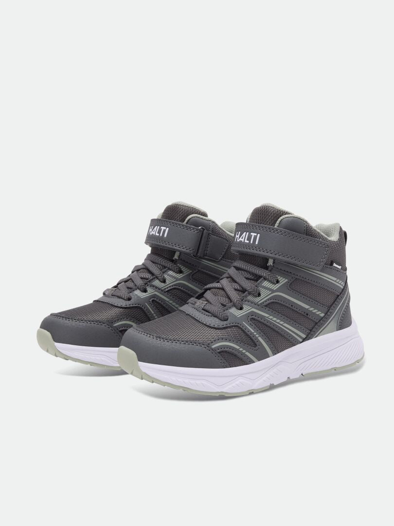 Halti Zuma Mid DX Kinder-Sneaker in Grau mit weißen Sohlen, Klettverschlüssen und Markenlogo auf der Zunge und an der Seite.
