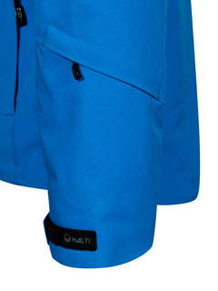 Nahaufnahme der Vertica DX Skijacke Herren von Halti: blauer Ärmel mit 4-Wege-Stretch, Reißverschlusstasche und schwarzem HALTI-Klettband.