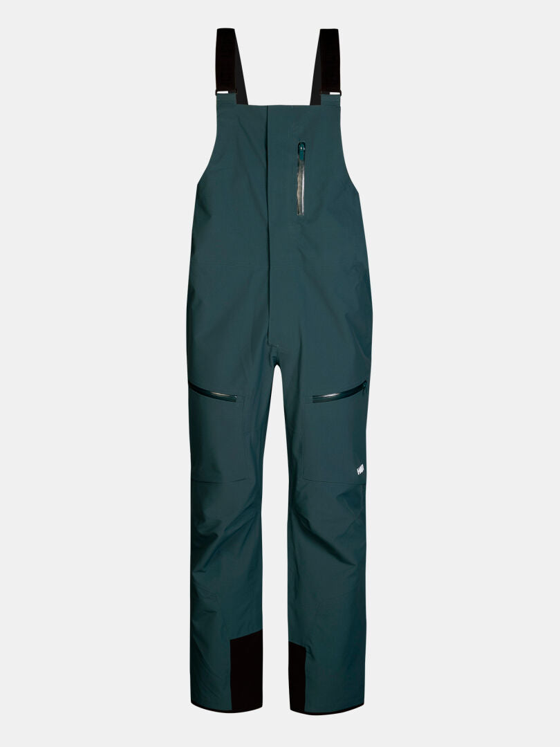 Halti Rizle 3L DX Skihose Unisex: atmungsaktive Skihose in Dunkelblaugrün mit schwarzen Schulterträgern und Reißverschlusstaschen.