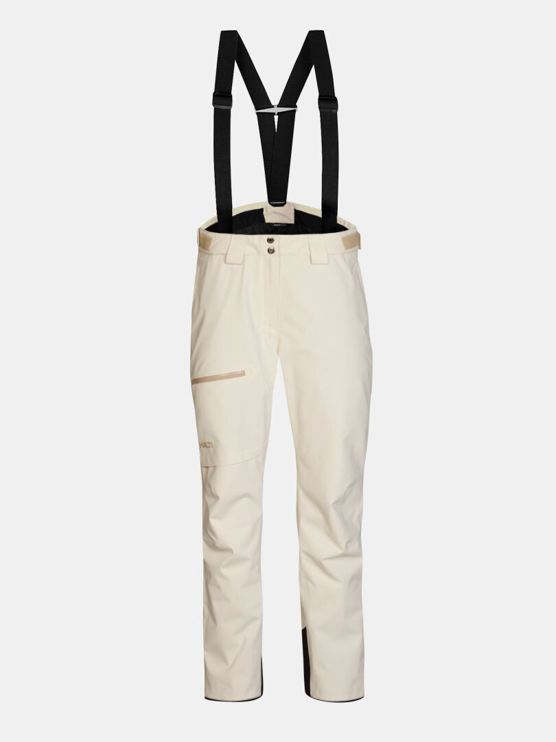 Cremefarbene Halti Carvey II DX Skihose für Damen mit schwarzen Hosenträgern und Seitentaschen mit Reißverschluss.