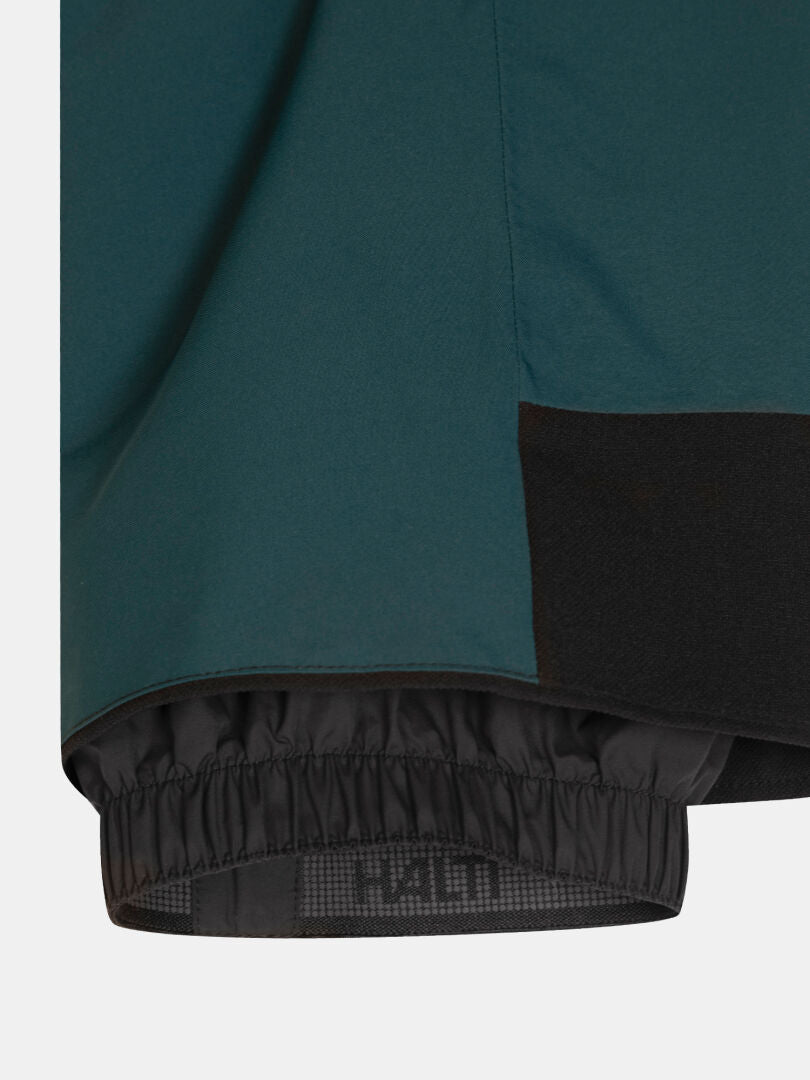 Dunkelgrüne Carvey II DX Skihose für Damen mit einer schwarzen, elastischen Schneeschutzmanschette am Saum.