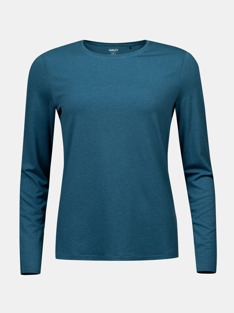 Das Halti Tuntu II Longsleeve Merinoshirt Damen in teal ist für den Einsatz im Freien auf einem hellgrauen Hintergrund abgebildet.