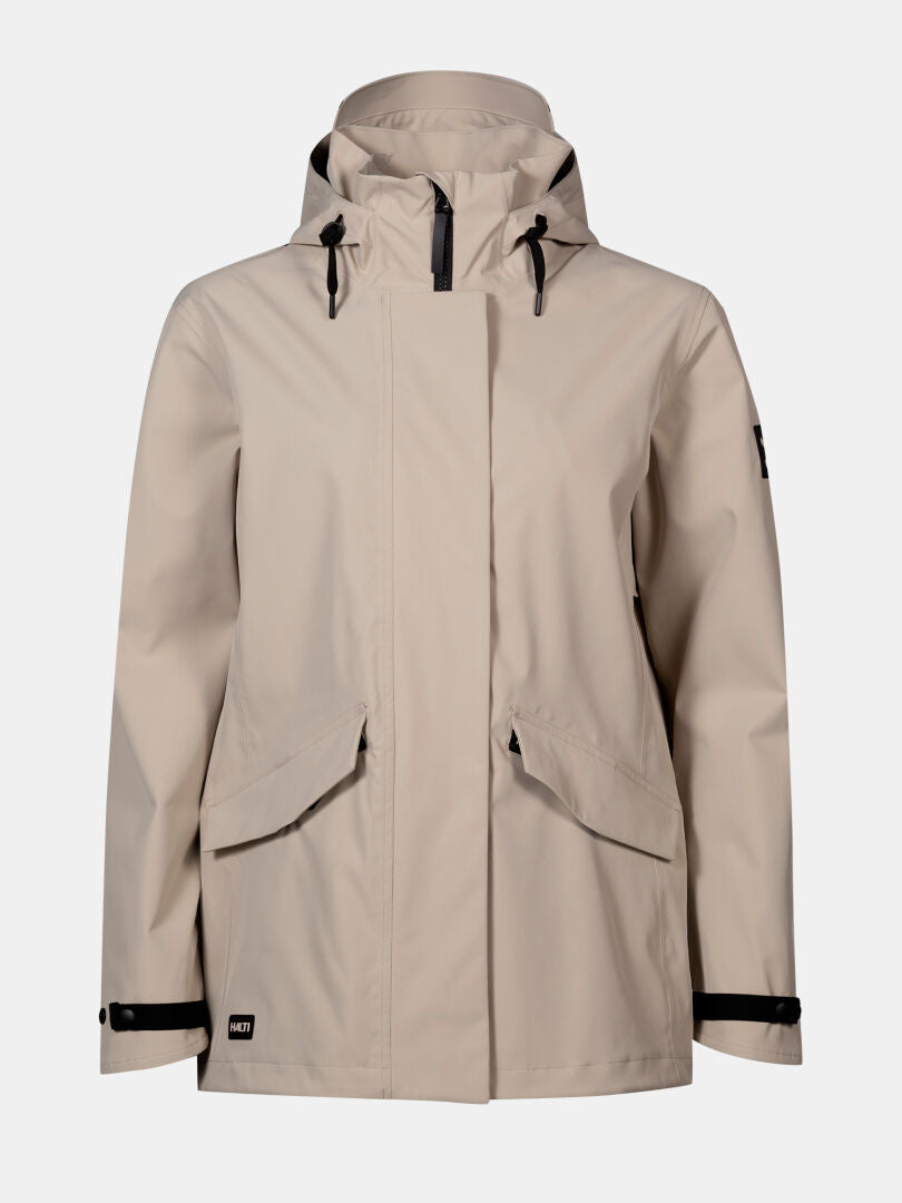 Halti Tokoi DX Jacke Damen: Beige, wetterfeste Kapuzenjacke mit Frontzipper und schwarzen, verstellbaren Details.