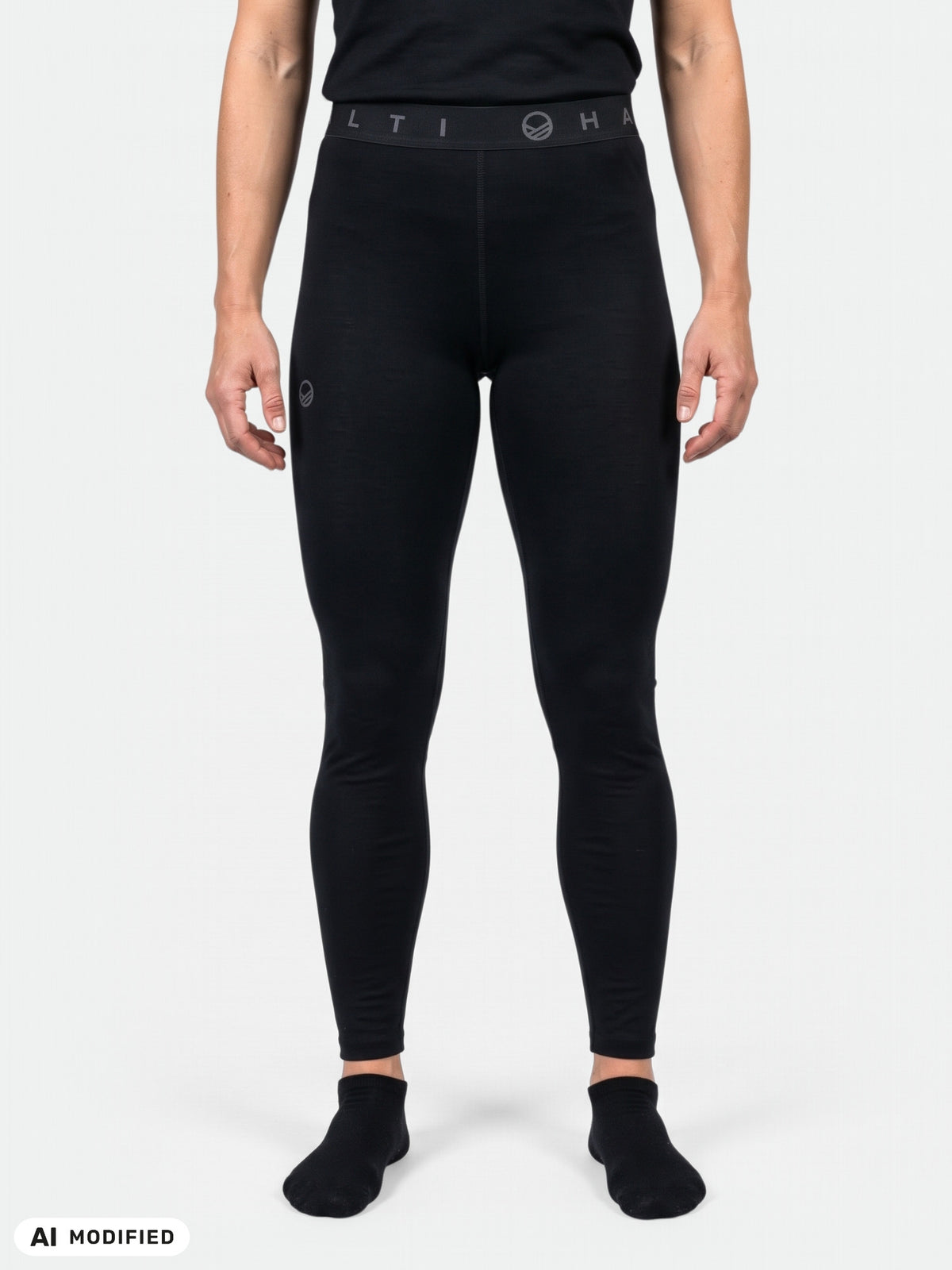 Eine Person in „Halti Pihka II Merinowolle Unterhosen Damen“-Leggings steht vor einem schlichten hellgrauen Hintergrund.
