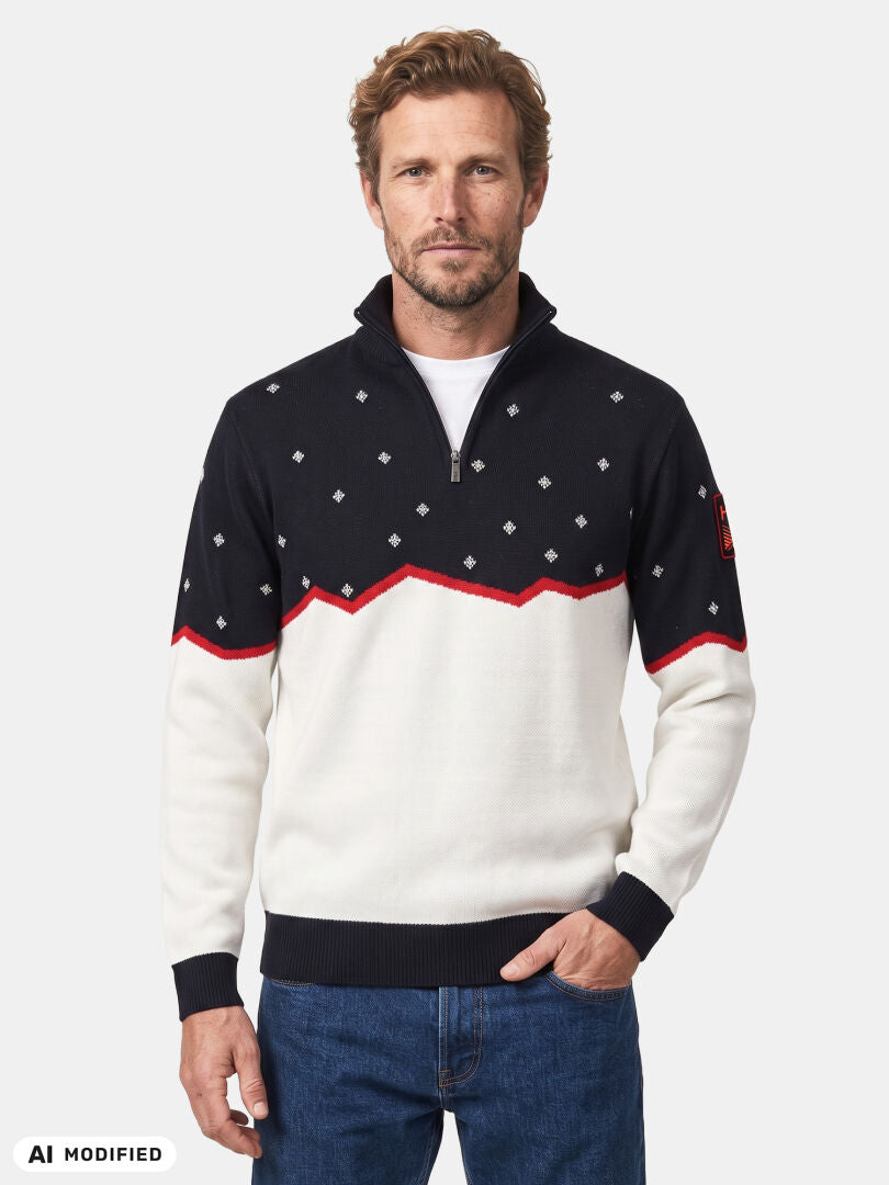 Ein Mann, der einen Halti Tauko Unisex-Pullover mit schwarzen, weißen und roten Akzenten trägt, steht mit den Händen in den Taschen und blickt nach vorne.